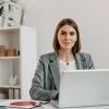business-woman-checkered-jacket-with-smile-while-sitting-desk-her-office